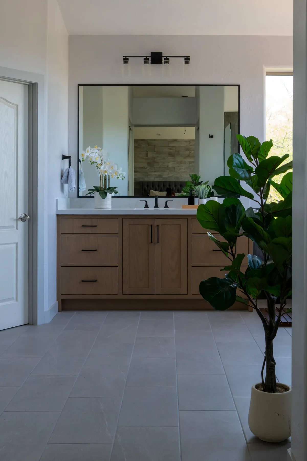 Marble bathroom vanity countertop with black fixtures in a Phoenix remodel