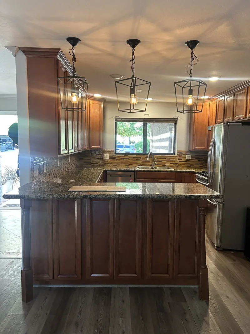 Original dark cherry cabinets and pendant lights before Phoenix remodel