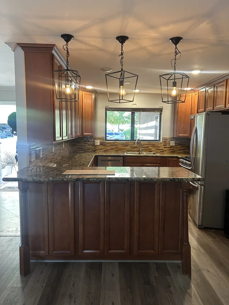 Kitchen mid-renovation with new lighting and flooring installed ahead of cabinet replacement, Phoenix remodel