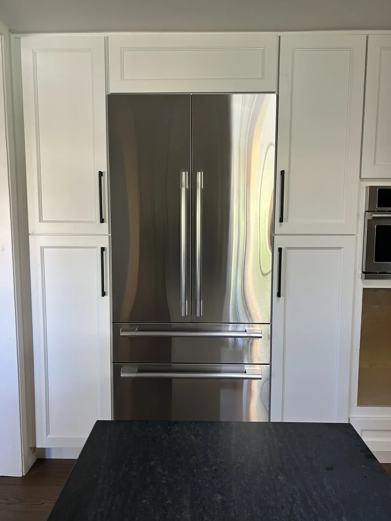 Built-in refrigerator integrated into white cabinetry, Scottsdale remodel