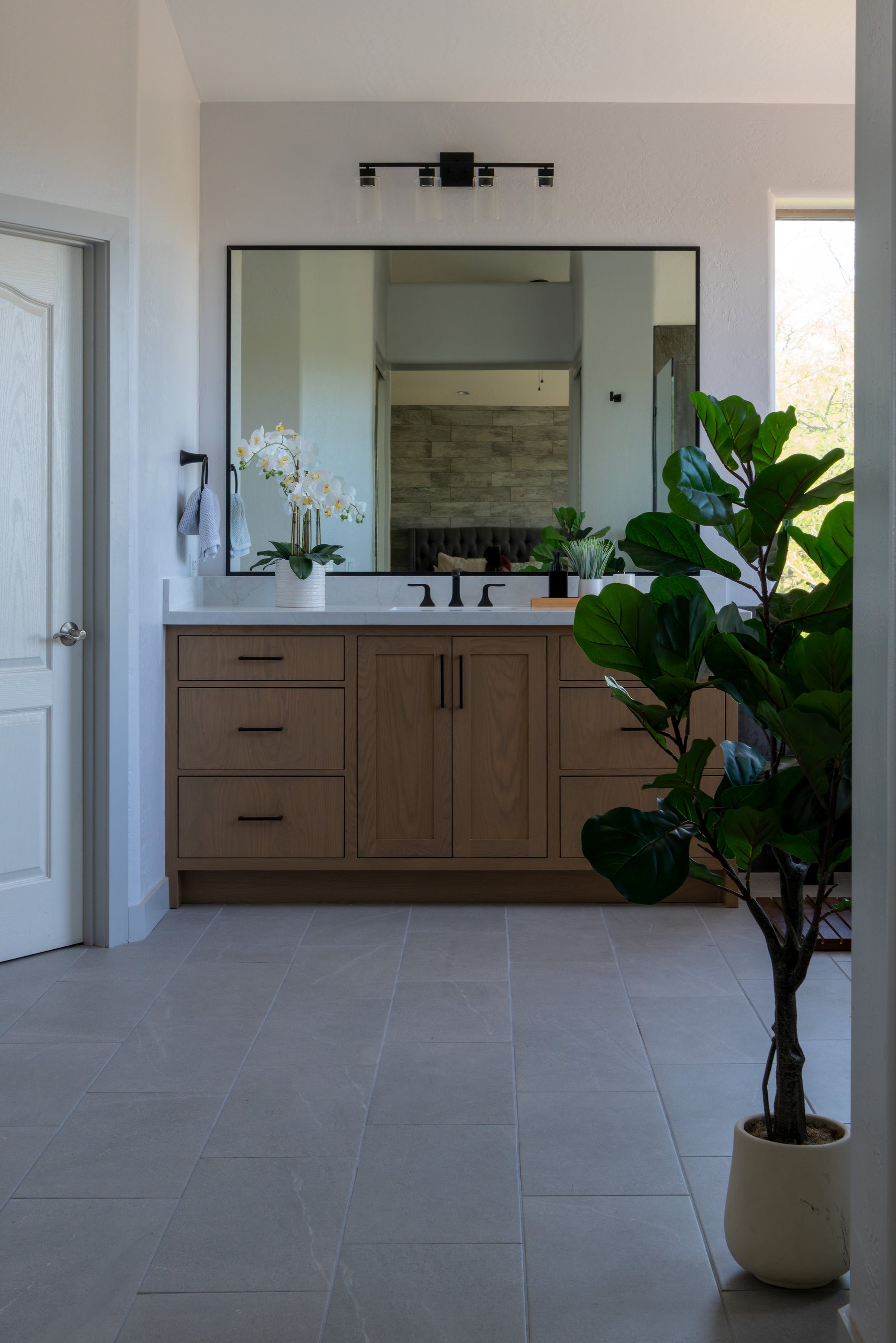 Marble bathroom vanity countertop with black fixtures in a Phoenix remodel