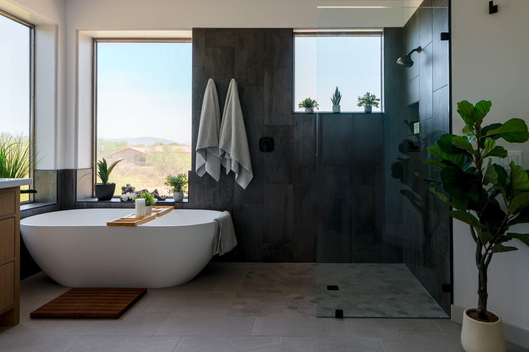 Large-format tile flooring in a Phoenix bathroom remodel with tub and glass shower